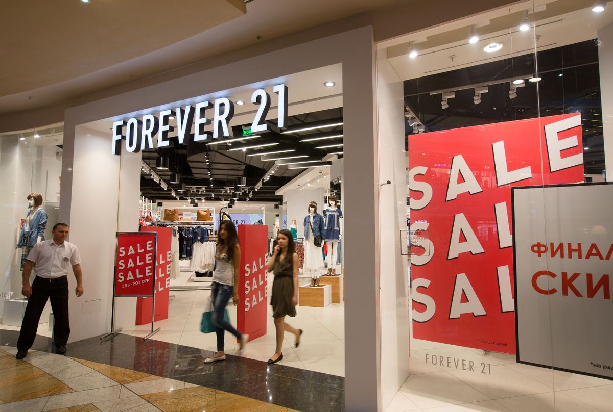 Sales discount signs sit in the window of a Forever 21 fashion store in the Afimall retail and entertainment center at the Moscow International Business Center in Moscow, Russia, on Saturday, Aug. 8, 2015. Policy makers are trying to avoid another ruble collapse after foreign debt repayments by companies last year helped spark Russias worst currency crisis since 1998.