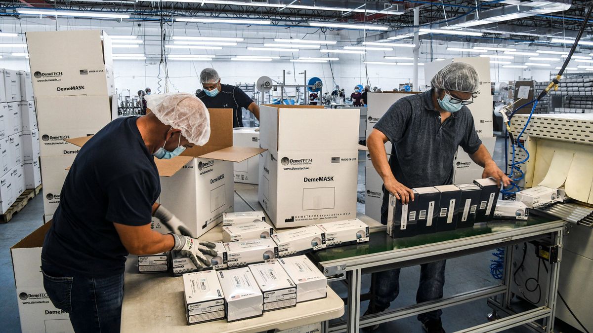 Employees work as they make respiratory masks in a family-owned medical equipment factory in north Miami, Florida on February 15, 2021. - A Florida company that saw an opportunity in the N95 mask shortage when the coronavirus pandemic began last year now has 30 million unsold masks because it can't find buyers in the United States. DemeTech, a Miami-based factory, blames lower prices from China, while a wholesale buyer thinks instead that the problem is that US buyers are wary of new manufacturers. (Photo by CHANDAN KHANNA / AFP)