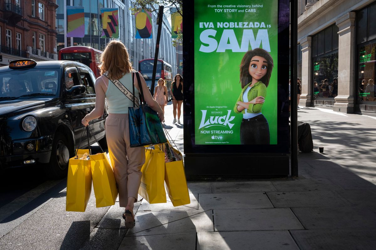 A woman shopper carries handfuls of Sefridges shopping bags towards a black cab on Oxford Street in the West End, on 12th August 2022, in London, England. After the Bank of England raised interest rates to 1.75%, there is a certainty that Britain will be in recession by the fourth quarter of 2022 and with inflation to climb further. 