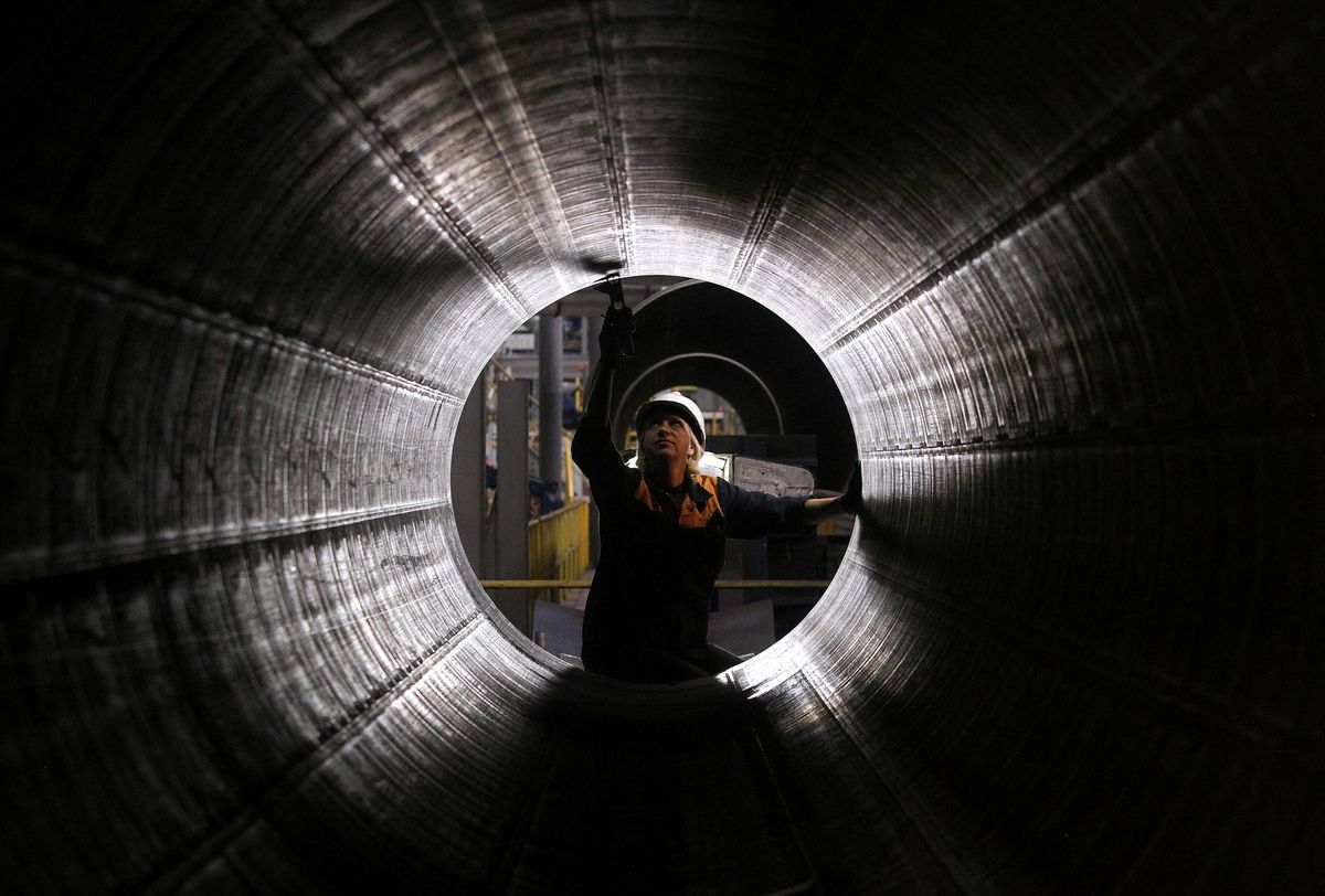 127489118 An OAO TMK employee checks a steel pipe as it sits on the production line at the company's plant in Volzhsky, near Volgograd, Russia, on Thursday, Sept. 22, 2011. Russia's largest producer of steel pipes for the oil and gas industry, isn't planning a secondary offering this year, its billionaire owner Dmitry Pumpyansky said. Photographer: Andrey Rudakov/Bloomberg via Getty Images