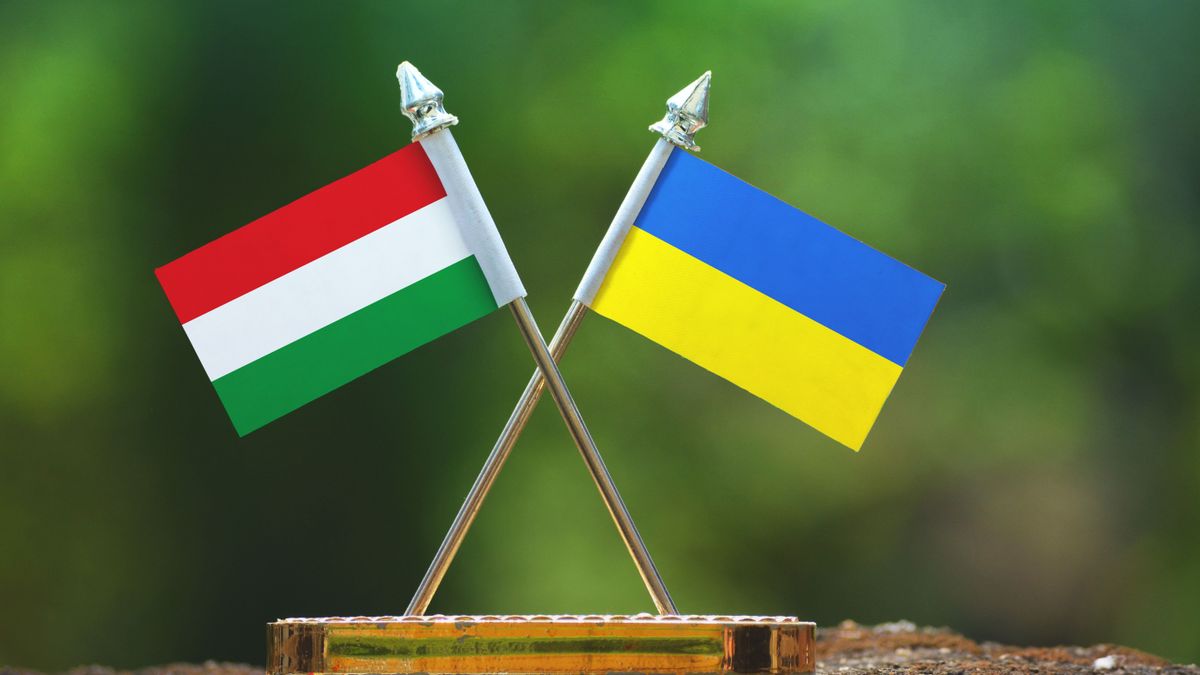 Ukraine,And,Hungary,Small,Flag,With,Blur,Green,Background