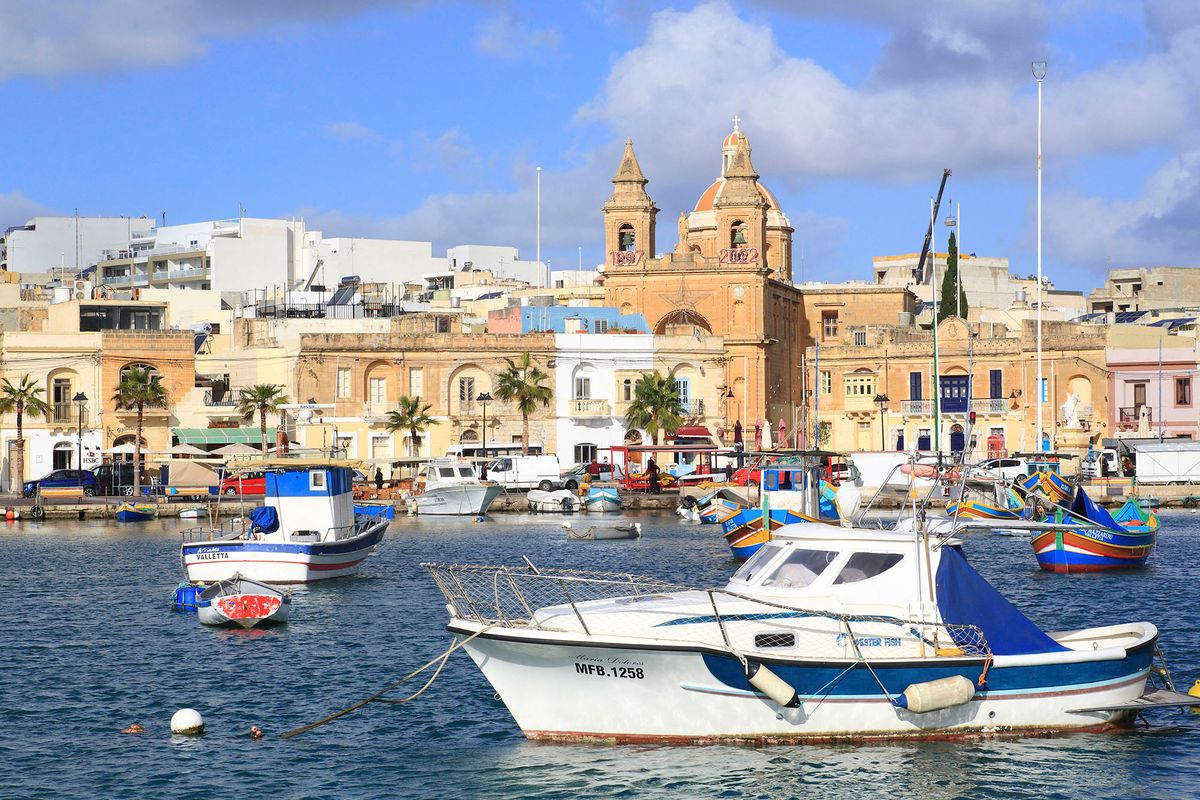 Malta, Marsaxlokk, fishing port founded by the Phoenicians in the 9th century BC. JC with in the background the facade of the parish church of Our Lady of Pompei (1897) (Photo by MAISANT Ludovic / hemis.fr / hemis.fr / Hemis via AFP)