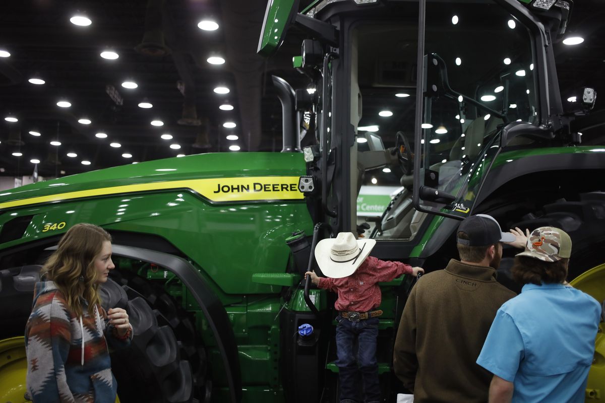 Attendees view Deere & Co. brand John Deere equipment at the National Farm Machinery Show in Louisville, Kentucky, U.S., on Friday, Feb. 18, 2022. The National Farm Machinery Show has 900 exhibitor booths, making it the countrys largest indoor farm show. Photographer: Luke Sharrett/Bloomberg via Getty Images