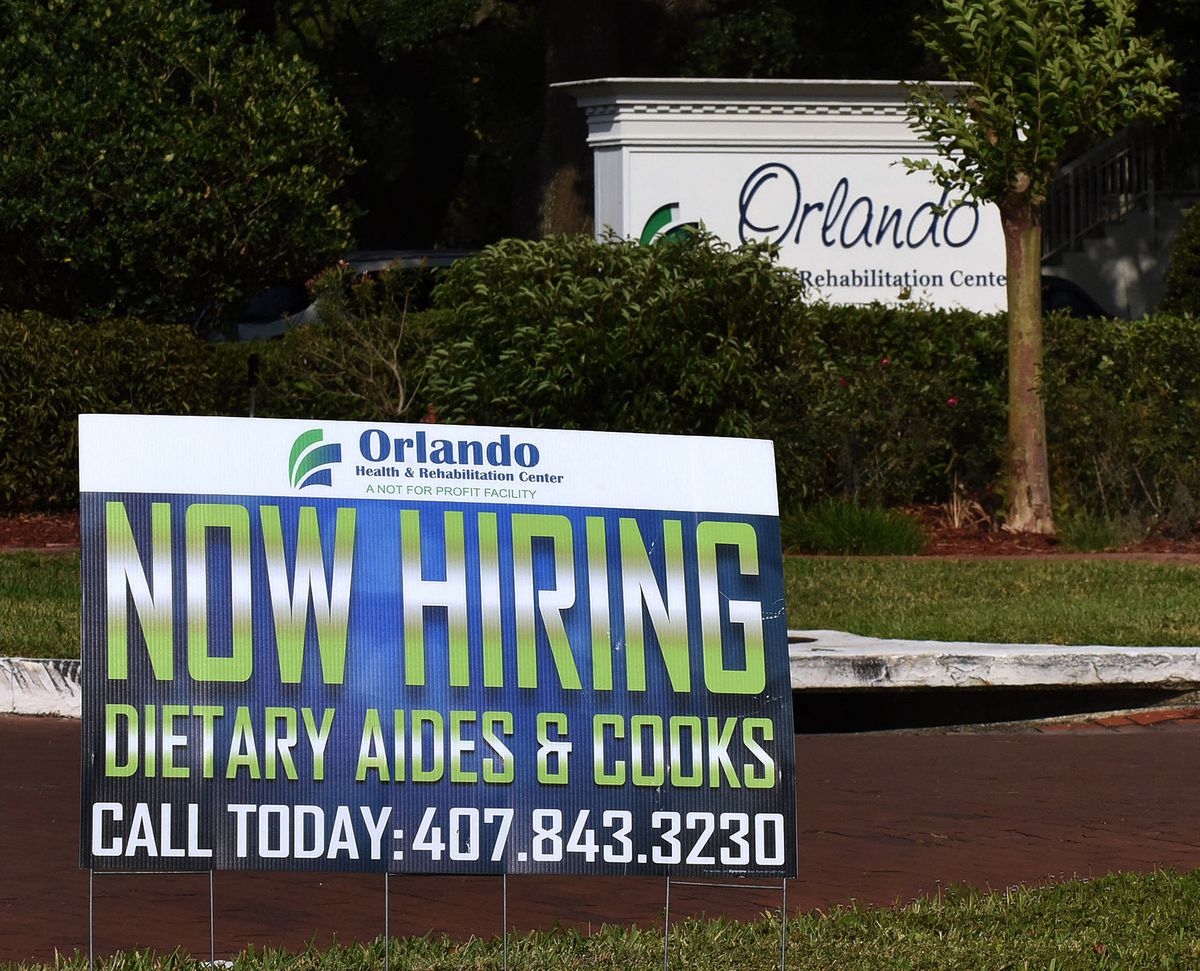 A Now Hiring sign is seen on April 17, 2021 in Orlando, Florida, USA. Businesses in Central Florida are having difficulty filling openings, with owners attributing the shortage of workers to COVID concerns by employees and a preference by many to remain at home while receiving state jobless benefits combined with the weekly unemployment bonus of $300 provided for under the American Rescue Plan.  (Photo by Paul Hennessy/NurPhoto) (Photo by Paul Hennessy / NurPhoto / NurPhoto via AFP)