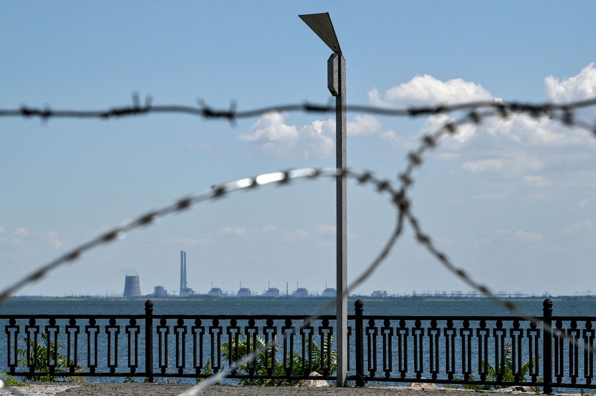 Daily Russian shelling of Nikopol, NIKOPOL, UKRAINE - JULY 20, 2022 - The Zaporizhzhia Nuclear Power Plant in Enerhodar, Zaporizhzhia Region, is seen through barbed wire on the embankment in Nikopol, Dnipropetrovsk Region, central Ukraine. Russian invaders have been shelling Nikopol from the premises of the nuclear power plant. This photo cannot be distributed in the Russian Federation. NO USE RUSSIA. NO USE BELARUS. (Photo by Dmytro Smolyenko / NurPhoto / NurPhoto via AFP)