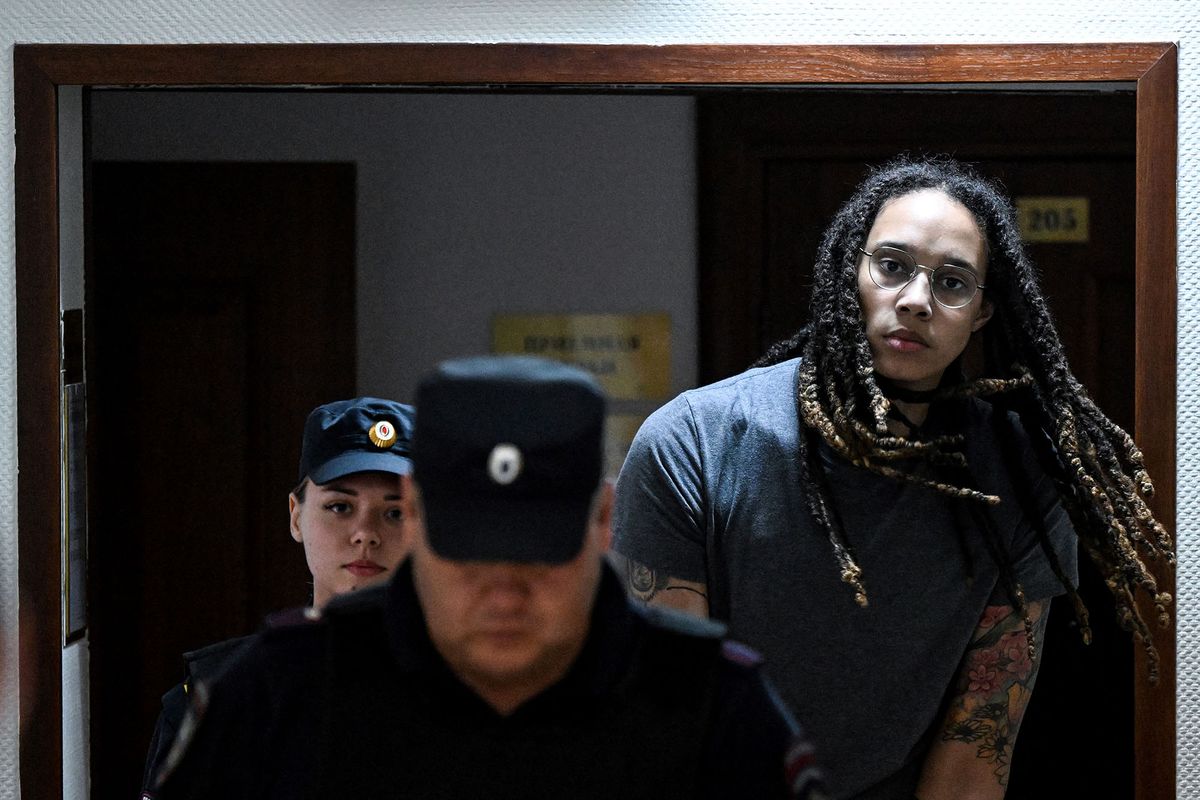 (FILES) In this file photo taken on August 04, 2022 US Women National Basketball Association's (WNBA) basketball player Brittney Griner, who was detained at Moscow's Sheremetyevo airport and later charged with illegal possession of cannabis, is escorted to the courtroom to hear the court's final decision in Khimki outside Moscow. - Brittney Griner, who was found guilty of drug possession and trafficking in Russia, has appealed her nine-year jail sentence, her lawyers said on August 15, 2022. (Photo by Kirill KUDRYAVTSEV / AFP)