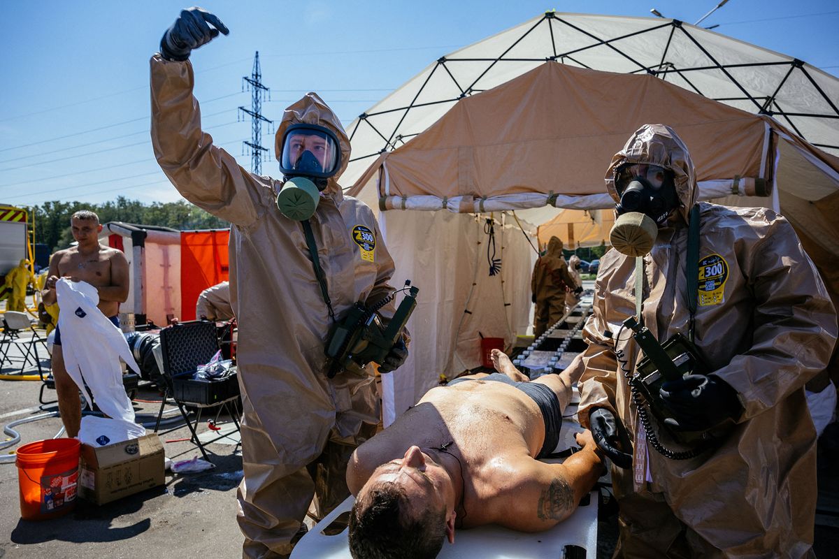 Ukrainian Emergency Ministry rescuers attend an exercise in the city of Zaporizhzhia on August 17, 2022, in case of a possible nuclear incident at the Zaporizhzhia nuclear power plant located near the city. - Ukraine remains deeply scarred by the 1986 Chernobyl nuclear catastrophe, when a Soviet-era reactor exploded and streamed radiation into the atmosphere in the country's north. The Zaporizhzhia nuclear power plant in southern Ukraine was occupied in the early days of the war and it has remained in Russian hands ever since. (Photo by Dimitar DILKOFF / AFP)