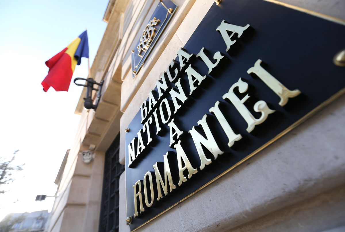 The Romanian national flag hangs from a flagpole outside the Romanian central bank, the Banca Nationala A Romaniei in the centre of Bucharest, Romania, on Wednesday, July 2, 2014. RomaniaÕs economy grew 3.8 percent from a year earlier in the first quarter, boosted by industry and exports. Photographer: Chris Ratcliffe/Bloomberg