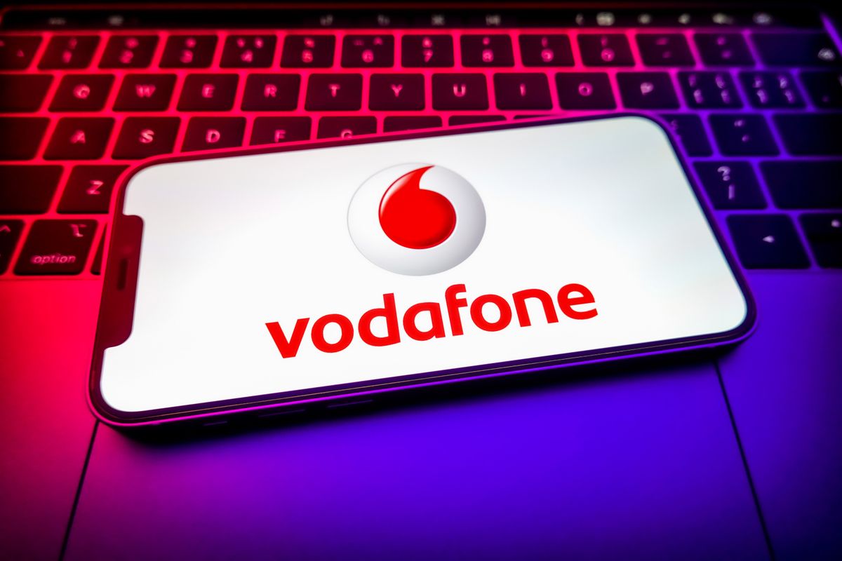 In this photo illustration, a Vodafone Group logo seen