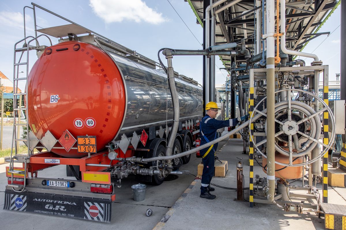 SZAZHALOMBATTA, HUNGARY - MAY 24: An employee loads an oil transport truck in the Duna oil refinery, on May 24, 2022 in Szazhalombatta, Hungary. MOL Hungarian Oil & Gas Plc is a multinational Hungarian oil and gas company headquartered in Budapest, Hungary. The Duna (Danube) Oil Refinery at Szazhalombatta, near Budapest is one of the biggest refineries in the Eastern-Central region of Europe where Russian oil arrives to Hungary via the Friendship (Druzhba) oil pipeline. 