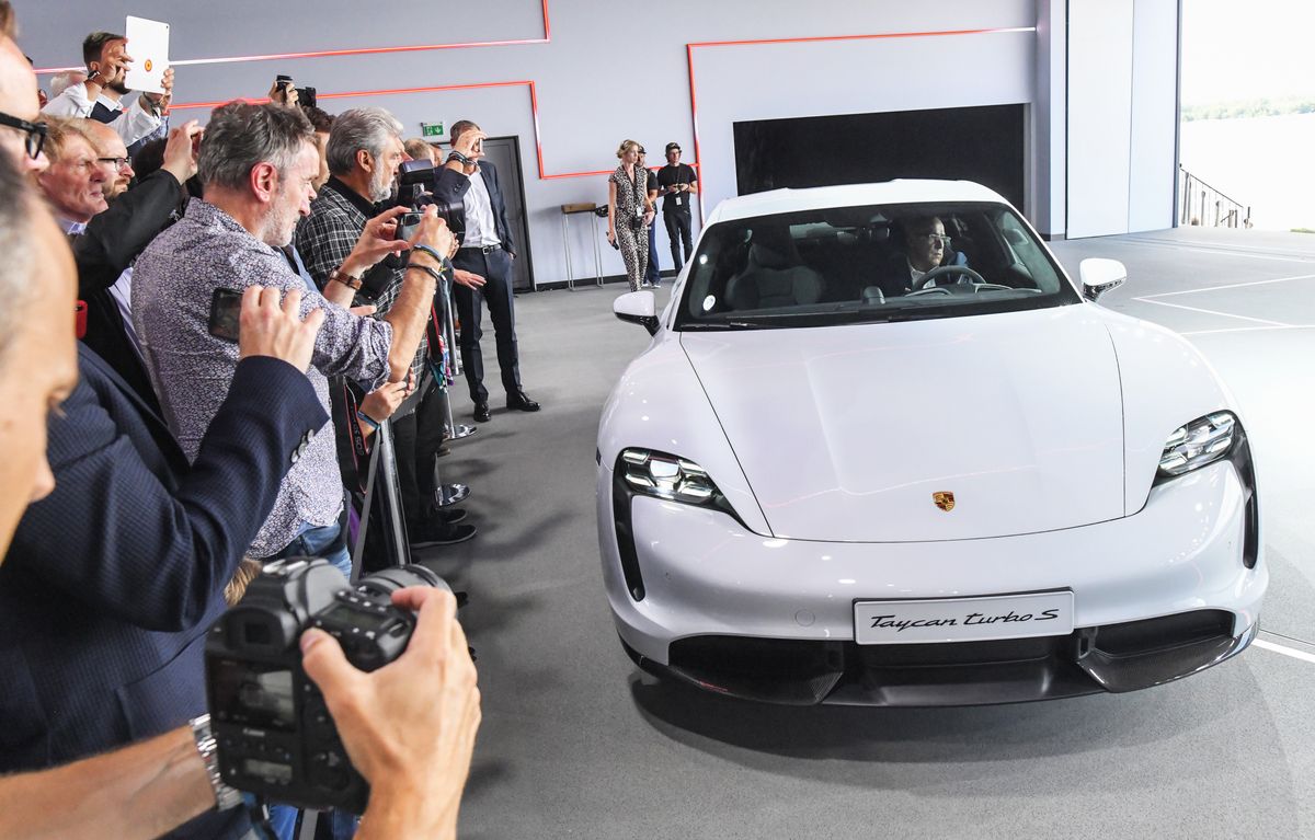 World premiere of the Porsche Taycan
04 September 2019, Brandenburg, Neuhardenberg: The Porsche Taycan will be presented to the public for the first time at the world premiere of the automobile group in a hall on the airport in Neuhardenberg. On Wednesday, the first purely electric model from Stuttgart-Zuffenhausen will celebrate its world premiere simultaneously on three continents. It will be delivered at the end of the year, the USA will make the start. The expectations are high. Porsche, like the industry as a whole, has been criticised for the diesel scandal and the debate about driving bans and is viewed with skepticism. Photo: Patrick Pleul/dpa-Zentralbild/dpa (Photo by Patrick Pleul/picture alliance via Getty Images)