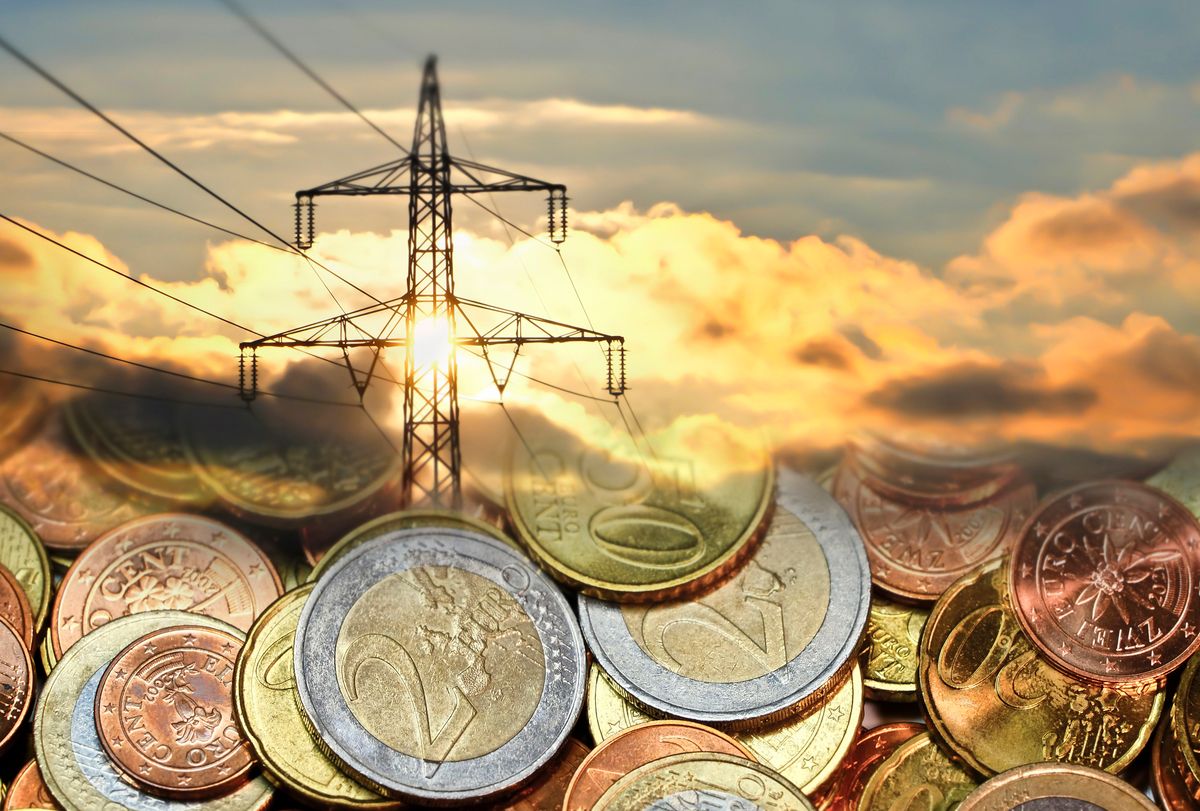 Concept for rising energy costs, High voltage power line in connection with euro coins.