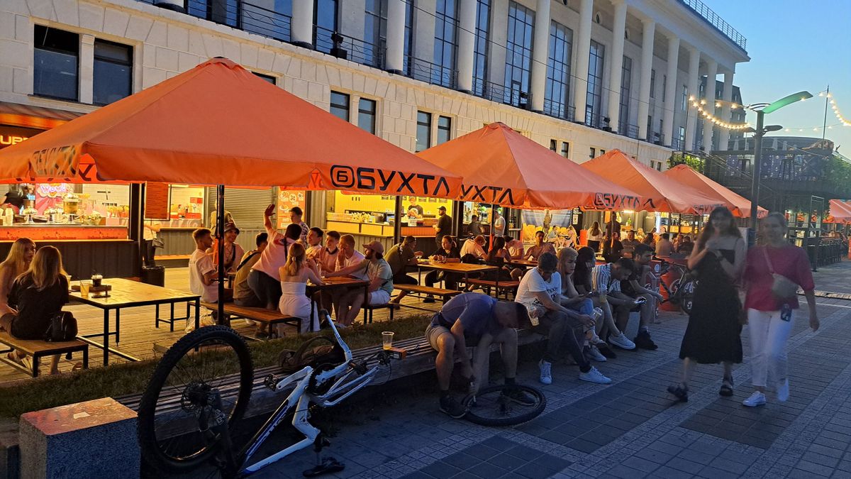 28 July 2022, Ukraine, Kiew: People are enjoying drinks in the outdoor area of a restaurant. (to dpa "Ice, tanks, air alarms - Kiev and the search for normality in war") 