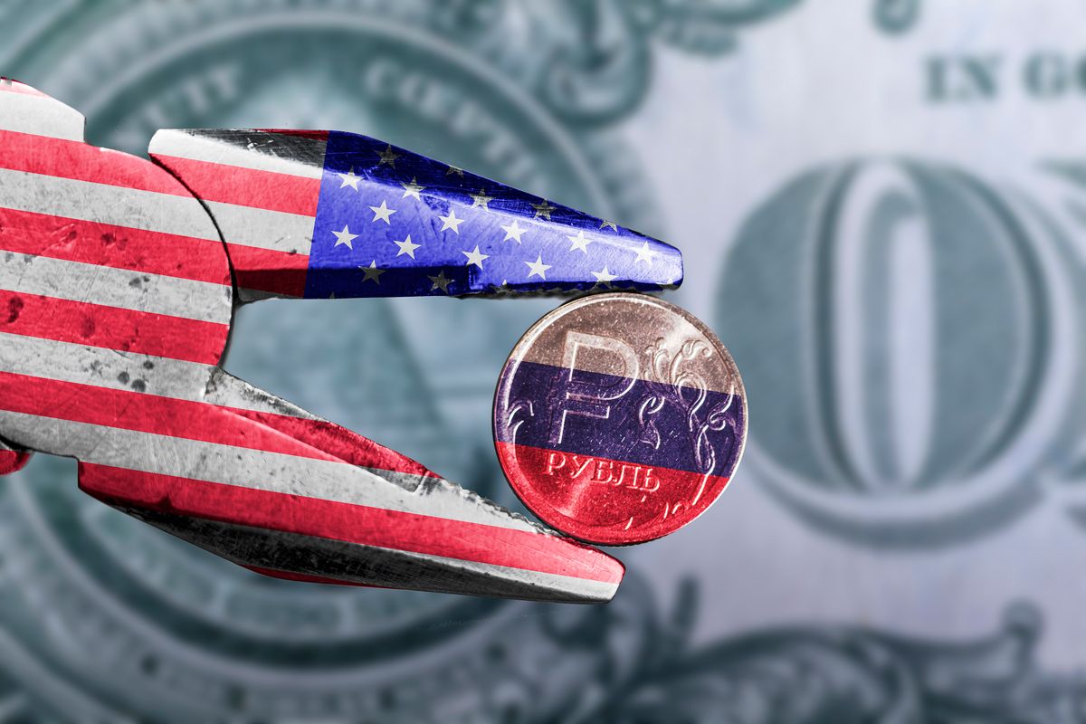 New Sanctions against the Russian economy. Pliers with USA flag squeezed the ruble with Russian flag, the ruble exchange rate against the  New Sanctions against the Russian economy. Pliers with USA flag squeezed the ruble with Russian flag, the ruble exchange rate against the dollar 