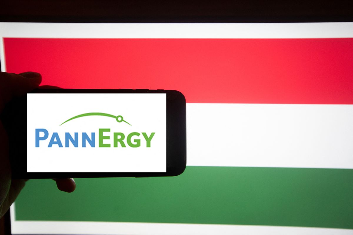 The logo of PannErgy Nyrt. is seen on a screen of a smartphone in front of a hungarian flag. It is part of the BUX, the major index of Hungary. 