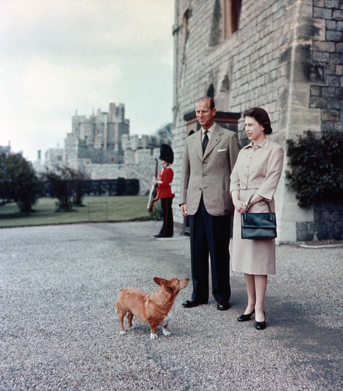 Queen Elizabeth II and Duke of Edinburgh at Windsor joined by Sugar, one of the Royal corgis. (Photo by PA Images via Getty Images)