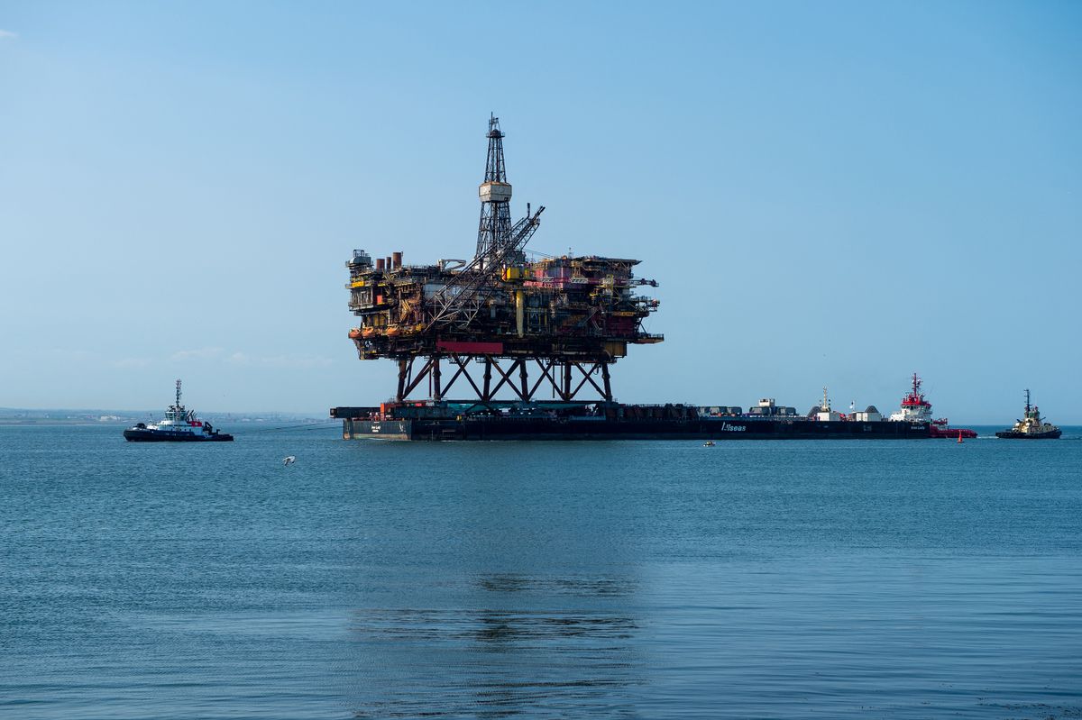 The 17,000 tonne Brent Alpha Topside Oil Rig is brought into the River Tees on the Allseas 200m long wide cargo barge the Iron Lady at South Gare, Redcar for dismantling at the Able UK yard, Hartlepool, County Durham, UK, on June 24, 2020.