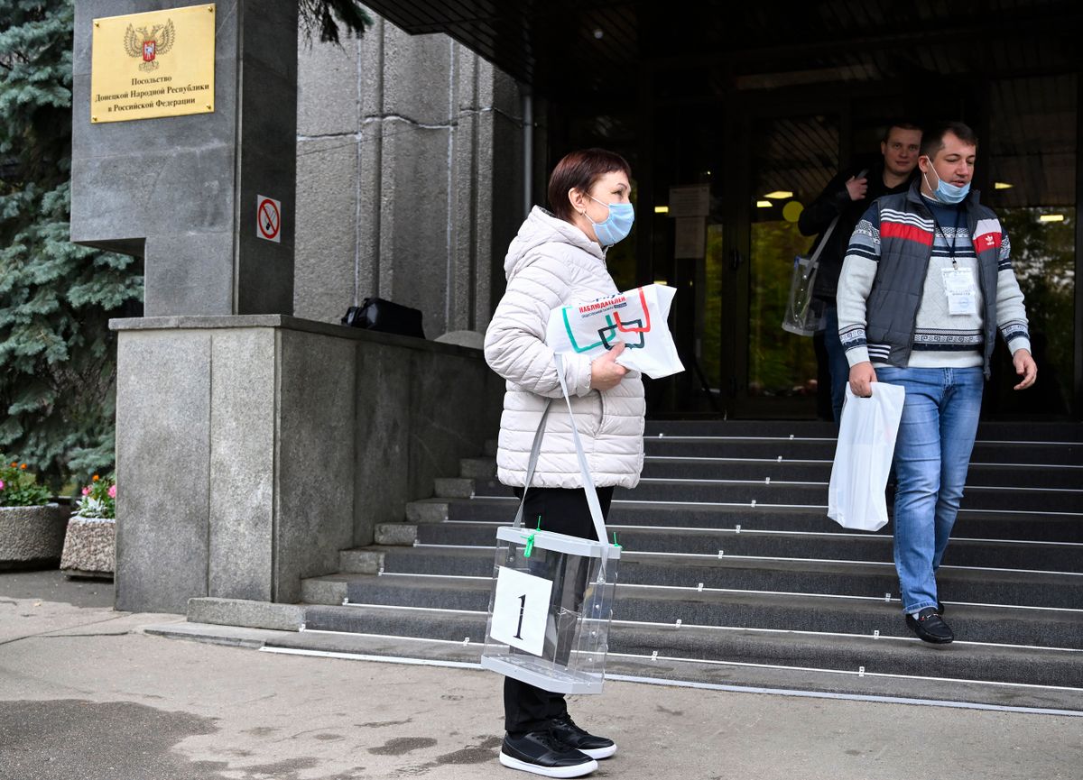 Election commission members with mobile ballot boxes leave the embassy of the self-proclaimed Donetsk People's Republic (DNR), the eastern Ukrainian breakaway region, in Moscow on September 23, 2022, as Moscow-held regions of Ukraine vote in annexation referendums that Kyiv and its allies say are illegal and illegitimate.