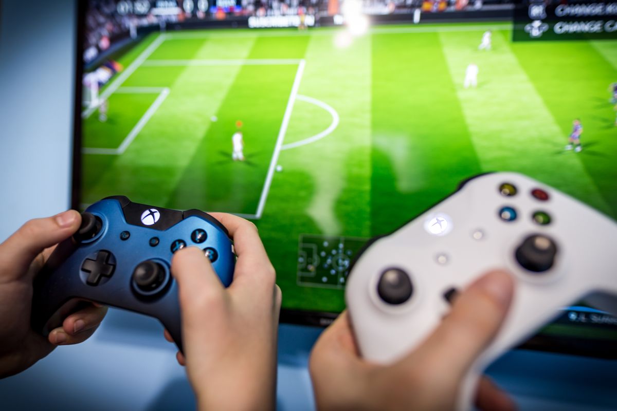 Debrecen,,Hungary,,Marc,11.,2018,View,From,The,Top,On, Debrecen, Hungary, Marc 11. 2018  View from the top on Xbox one s gamepad, game console, kid holding in his hands. Blurred background view and gaming concept. 2018 Fifa World Cup concept design, Debrecen, Hungary, Marc 11. 2018  View from the top on Xbox one s gamepad, game console, kid holding in his hands. Blurred background view and gaming concept. 2018 Fifa World Cup concept design
