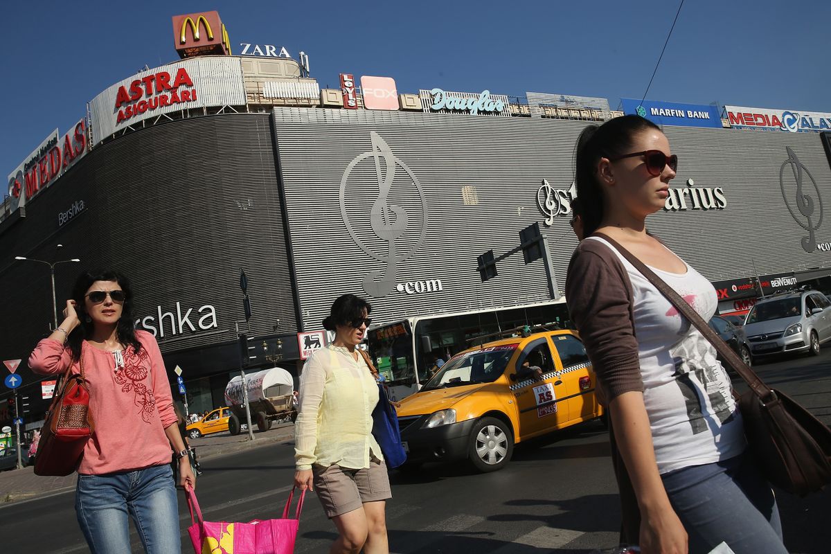 BUCHAREST, ROMANIA - SEPTEMBER 06:  Women walk past a shopping mall in the city center on September 6, 2013 in Bucharest, Romania. While the country's economic output has risen significantly since it joined the European Union in 2007, it still lags in infrastructure development and the fight against corruption.  