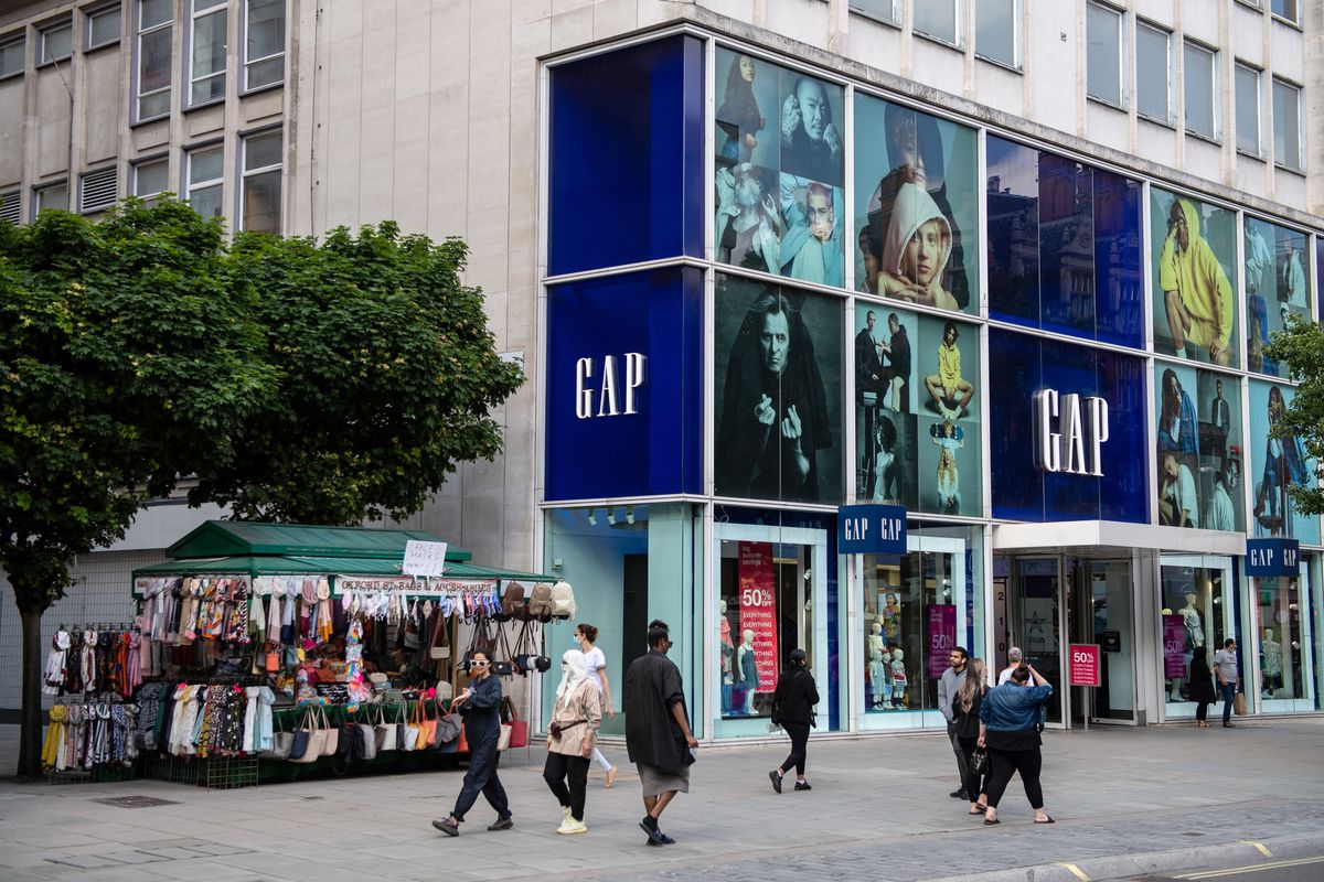 Gap To Close 19 UK and Ireland stores Amid Covid Pandemic Losses, LONDON, ENGLAND - JUNE 10: Shoppers pass the GAP store on Oxford Street on June 10, 2021 in London, England. The Gap clothing chain of shops announced closures of 19 UK and Ireland stores as the company experienced losses due to the coronavirus COVID-19 pandemic.  (Photo by Chris J Ratcliffe/Getty Images)