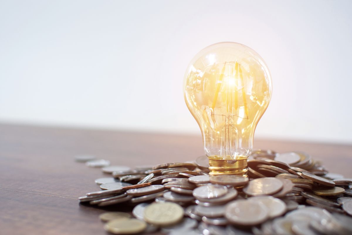 Light bulb and pile of coins with copy space, Light bulb and pile of coins with copy space