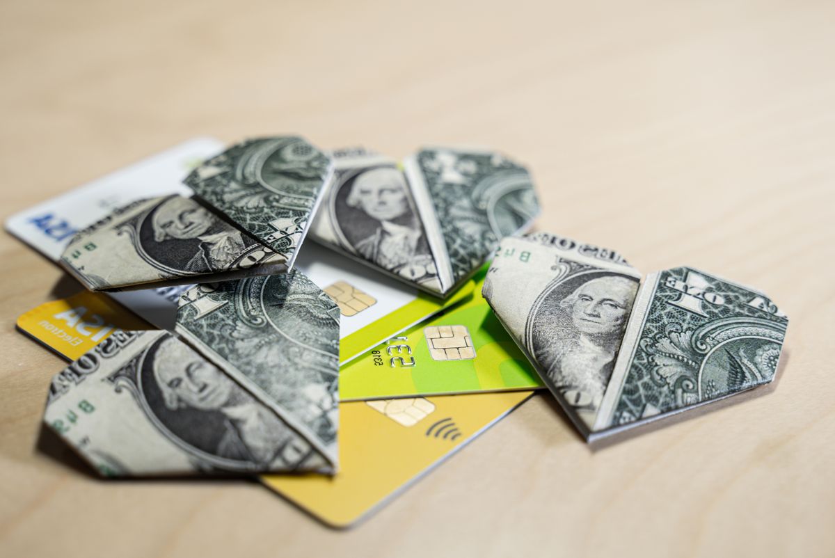 Credit,Cars,And,One,Dollar,Origami,Hearts.,Selective,Focus.,Suitable, Credit cars and One Dollar origami hearts. Selective focus. Suitable for greed, business, richness or money love concepts with available copy space.