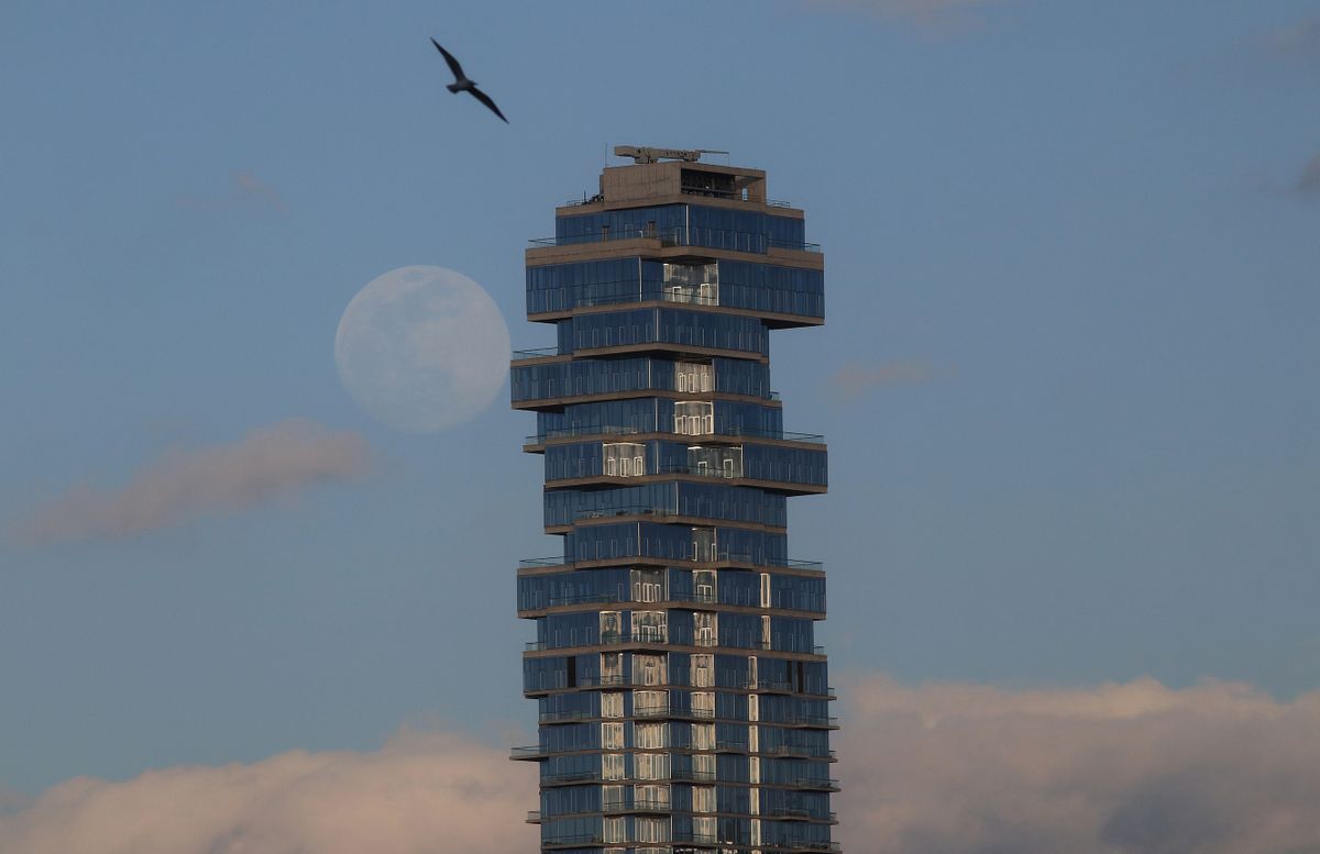 JERSEY CITY, NJ - MARCH 19: The moon rises over the Jenga Building at sunset in New York City on March 19, 2019 as seen from Jersey City, New Jersey. 