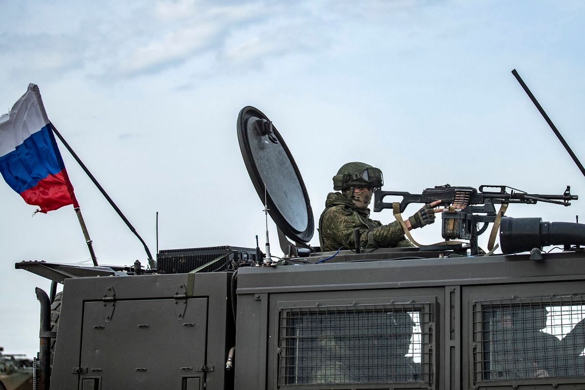 Russian troops are pictured in a joint convoy with Turkish troops (unseen) patrolling in oil fields near the town of al-Qahtaniyah, in Syria's northeastern Hasakeh province close to the Turkish border, on February 4, 2021. 