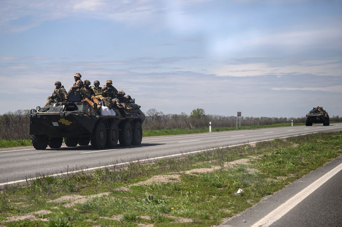 Ukrainian servicemen ride on an armoured personnel carrier (APC) as they make their way along a highway on the outskirts of Kryvyi Rih on April 28, 2022, on the 64th day of the Russian invasion of Ukraine. (Photo by Ed JONES / AFP)