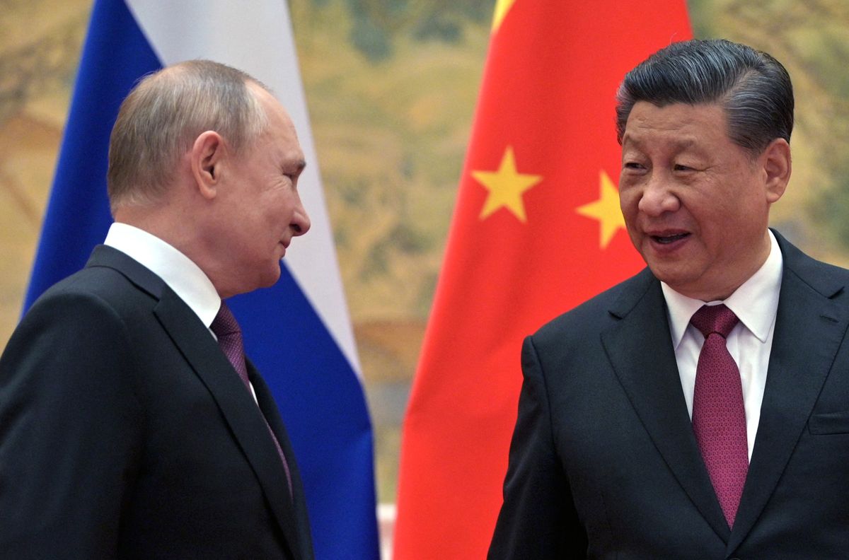 Russian President Vladimir Putin (L) and Chinese President Xi Jinping arrive to pose for a photograph during their meeting in Beijing, on February 4, 2022. (Photo by  / Sputnik / AFP)