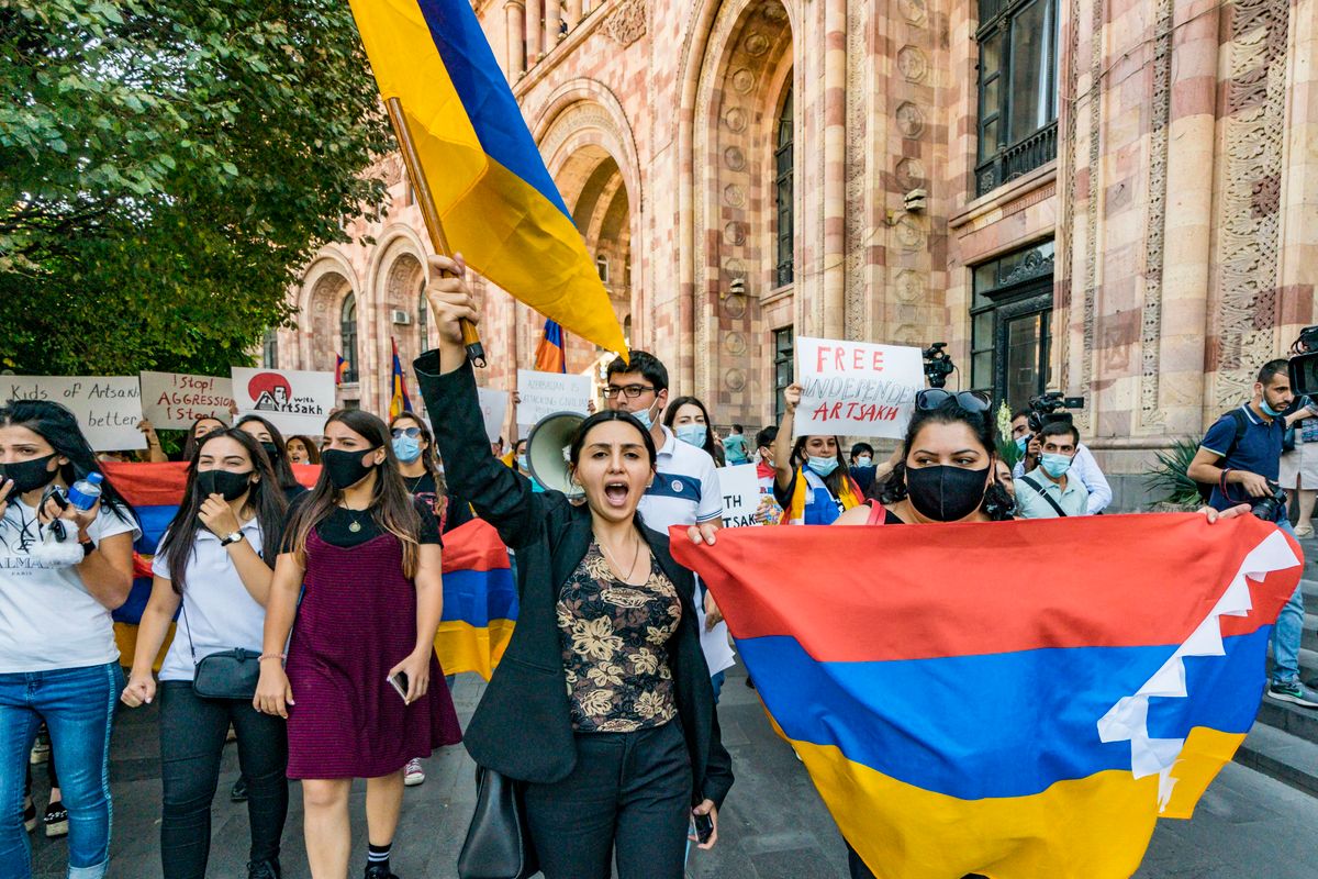 Demonstration In Yerevan Against The Azerbayan Attack, A woman shouts and holds a huge flag of Armenia during a demonstration in the streets of Yerevan, Armenia, on September 29, 2020 against the Azerbayan attacks on Nagorno Karabakh. (Photo by Celestino Arce/NurPhoto via Getty Images)