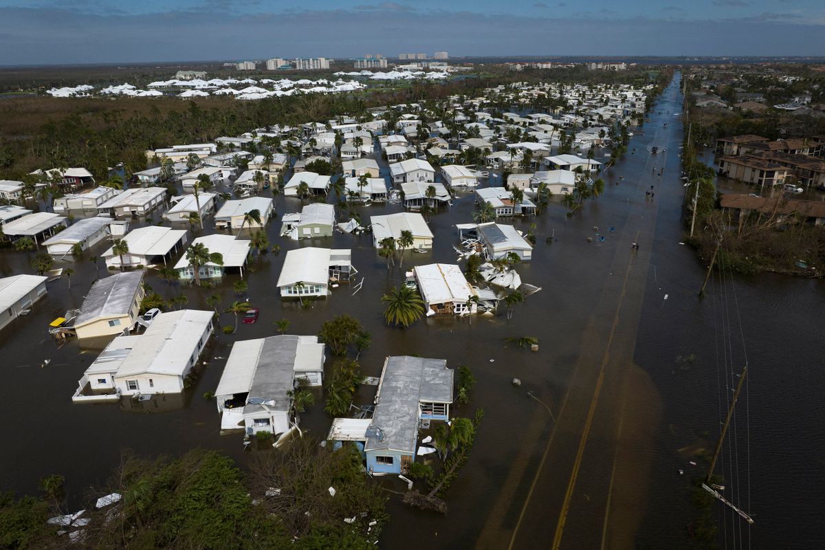 An aerial picture taken on September 29, 2022 shows a flooded neighborhood in the aftermath of Hurricane Ian in Fort Myers, Florida. - Hurricane Ian left much of coastal southwest Florida in darkness early on Thursday, bringing "catastrophic" flooding that left officials readying a huge emergency response to a storm of rare intensity. The National Hurricane Center said the eye of the "extremely dangerous" hurricane made landfall just after 3:00 pm (1900 GMT) on the barrier island of Cayo Costa, west of the city of Fort Myers. 