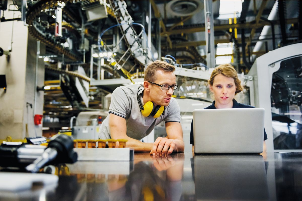 Engineers working on laptop in a large printer, német gazdaság, germany, factory, economy