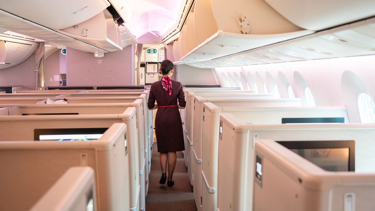 SHANGHAI, GUANGDONG, CHINA - 2019/10/03: Flight attendant walks in a business cabin of a Shanghai airlines Boeing 787-9 Dreamliner at the Shanghai Hongqiao International Airport