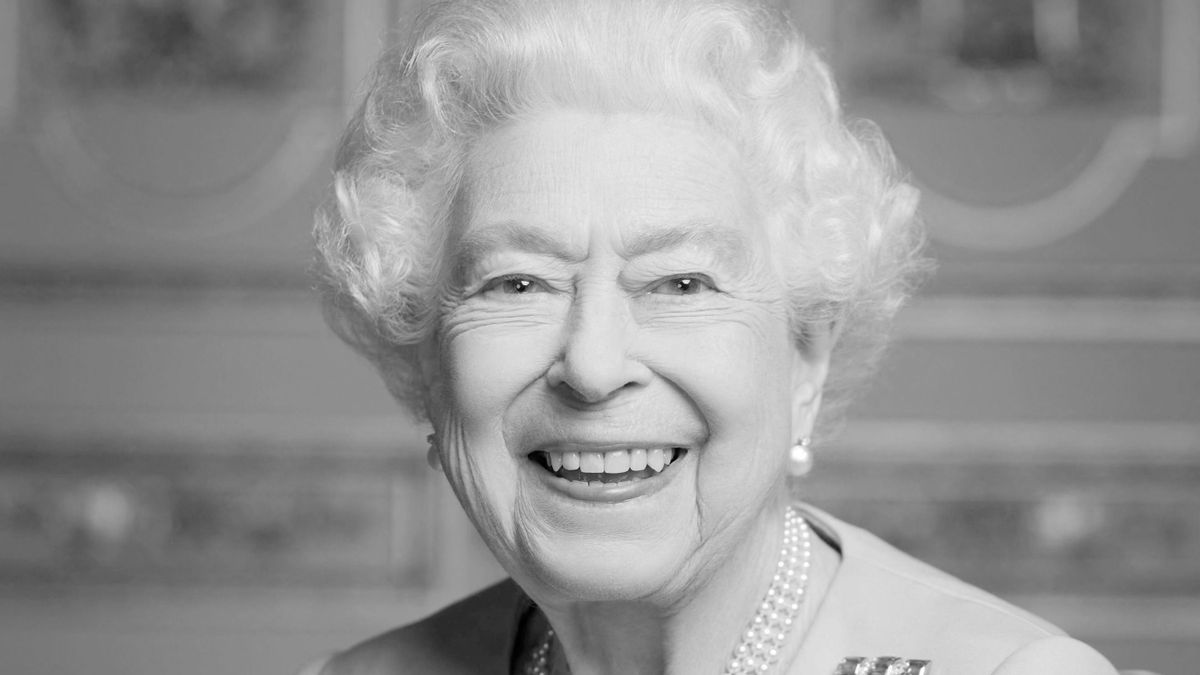 A handout image released by Buckingham Palace on September 18, 2022, shows Britain's Queen Elizabeth II smiling, photographed at Windsor Castle in May 2022. - Huge crowds built in central London from early morning on on September 19, 2022, to secure a spot to watch the state funeral of Queen Elizabeth II at Westminster Abbey. 
