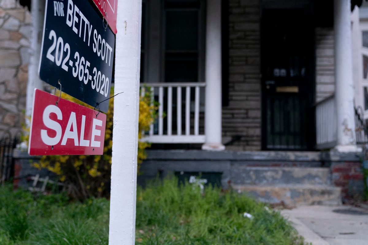 A “For Sale” sign is displayed in front of a house in Washington, DC, on March 31, 2022. (Photo by Stefani Reynolds / AFP)