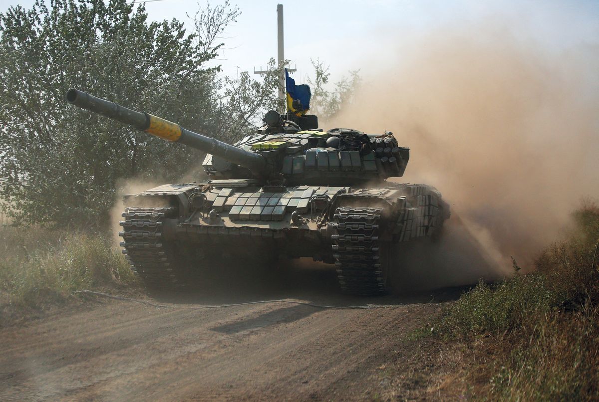 A Ukrainian tank rolls down a road at a position along the front line in the Donetsk region on August 15, 2022, amid Russia's invasion of Ukraine. (Photo by Anatolii Stepanov / AFP)