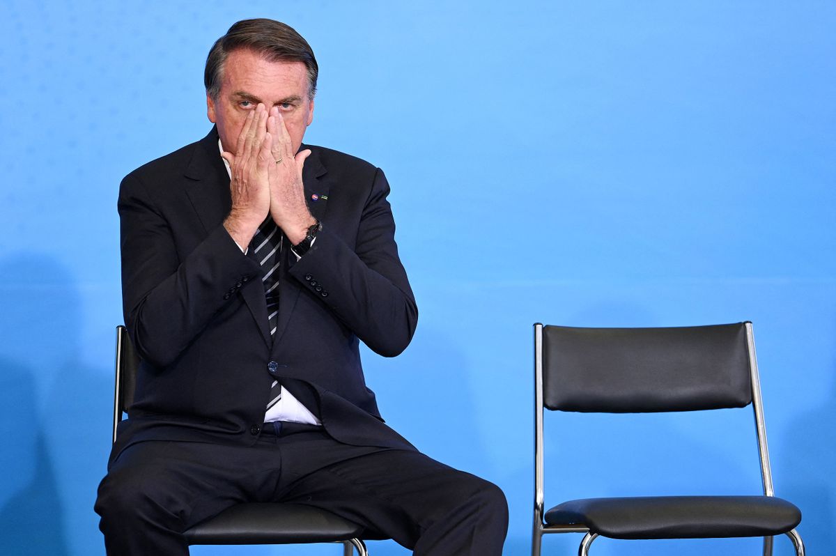 (FILES) In this file photo taken on August 26, 2021, Brazilian President Jair Bolsonaro gestures during the celebration of National Volunteer Day at Planalto Palace in Brasilia. - The outgoing Brazilian president Jair Bolsonaro, beaten in all the polls by his sworn enemy Lula, says he is sure of his victory in the first round of the October 2, 2022 election after four years of a mandate marked by crises. 