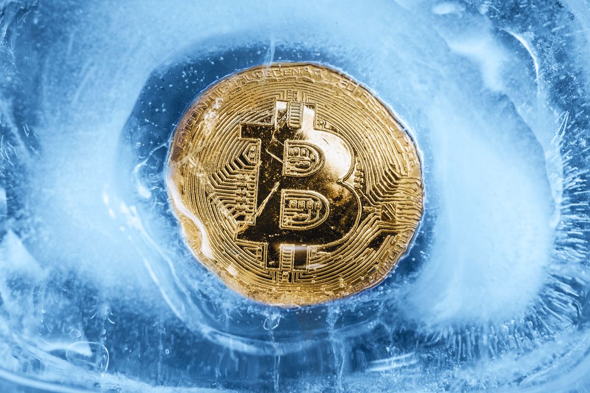 The,Gold,Coin,Of,Cryptocurrency,Bitcoin,Is,Freezing,In,The, The gold coin of cryptocurrency Bitcoin is freezing in the blue ice. The concept of the exchange in winter. The gold coin of cryptocurrency Bitcoin is freezing in the blue ice. The concept of the exchange in winter.