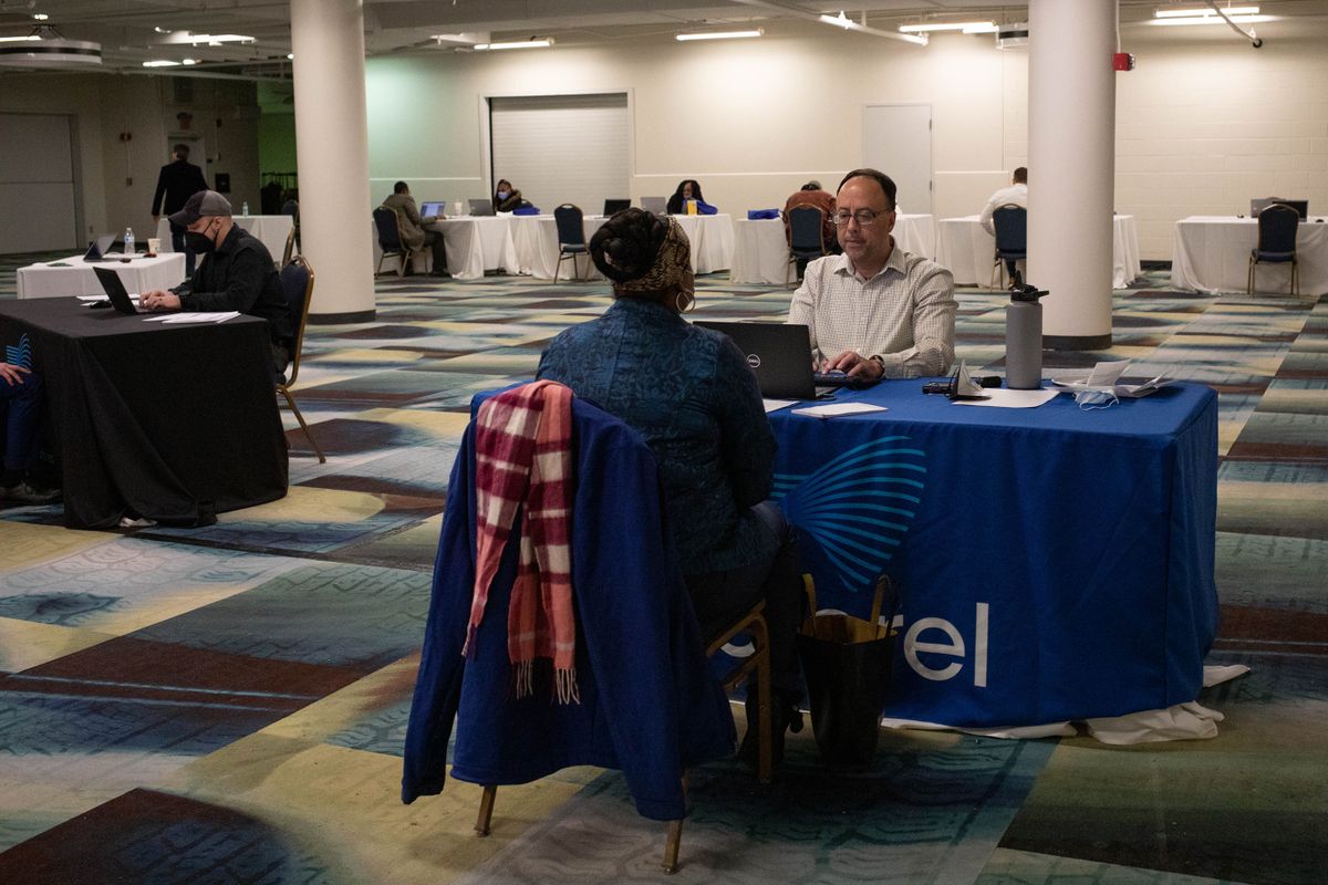 A representative conducts an interview during a job fair hosted by Majorel at the Renaissance Center in Detroit, Michigan, U.S., on Wednesday, Feb. 25 2022. The customer experience company plans to hire about 200 full time employees for their new office opening in downtown Detroit in the coming months. 