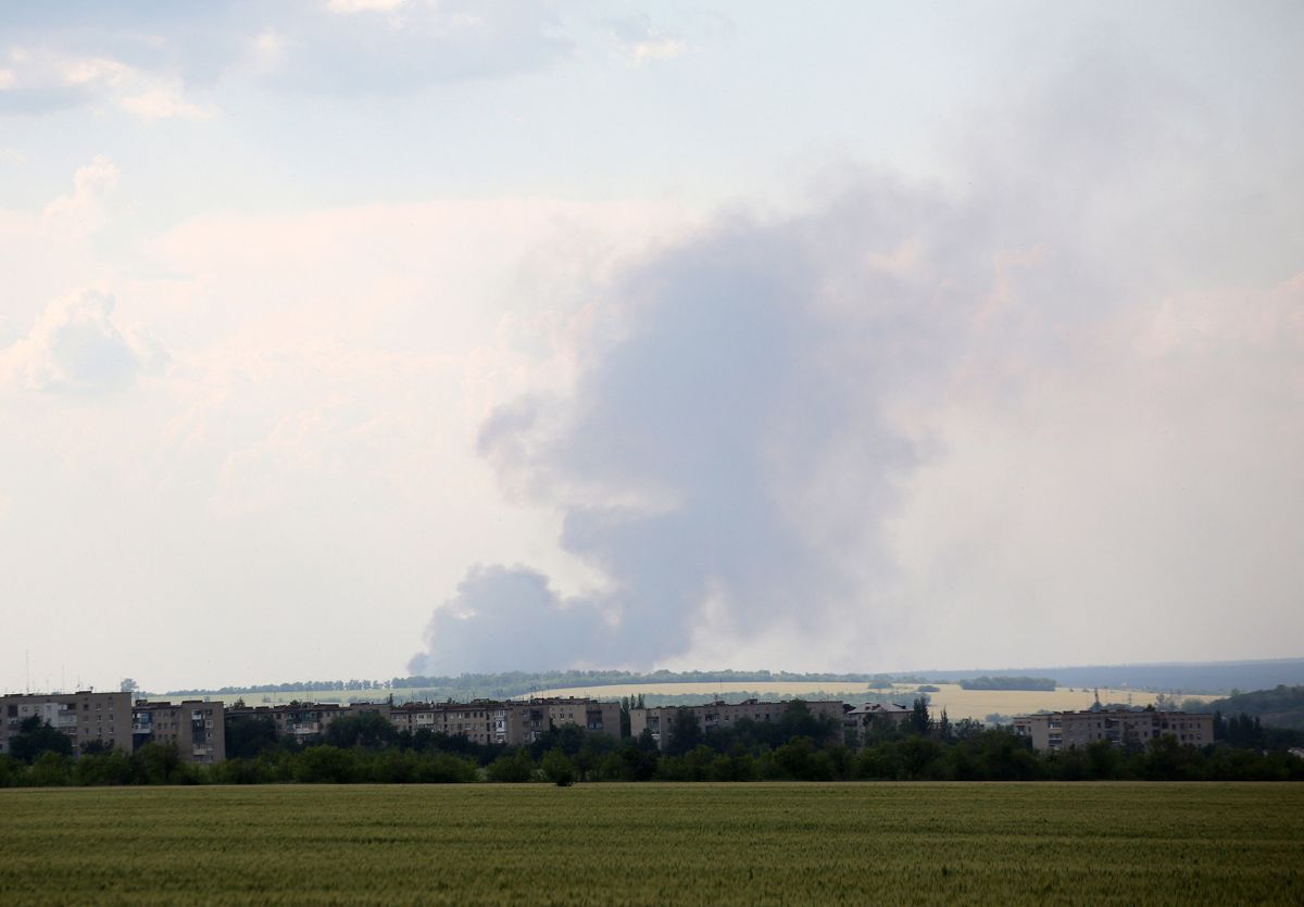 Black smoke is seen over the city of Lyman, Donetsk region, moving from the territory of the Luhansk region on June 14, 2022. 