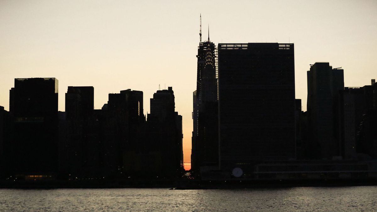 The sun sets behind 42nd Street in Manhattan during a power outage in New York City on July 13, 2019. Subway stations plunged into darkness and the billboards of Times Square suddenly flicked off as New York's Manhattan was hit by a power outage on Saturday. About 42,000 customers lost electricity in the early evening, according to the Con Edison utility, which did not give a reason for the cut.