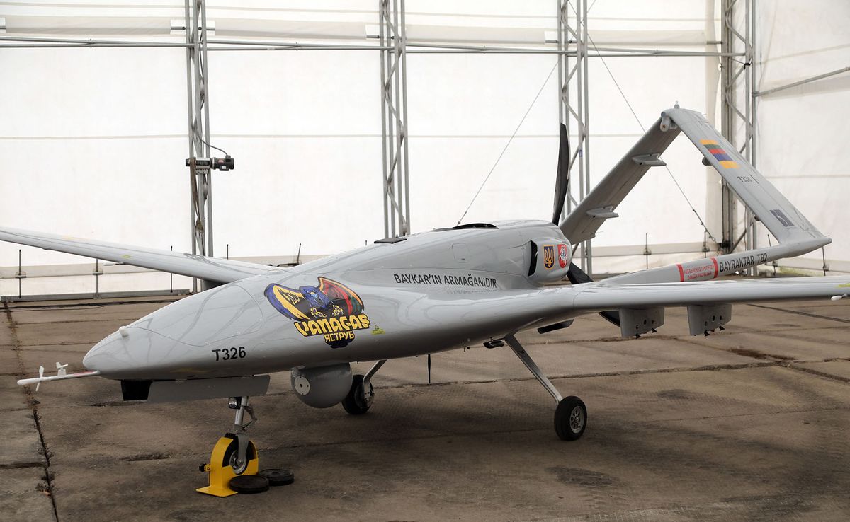 A Turkish Bayraktar TB2 combat drone is on view during a presentation at the Lithuanian Air Force Base in Siauliai, Lithuania, on July 6, 2022. - Lithuania on July 6, 2022 exhibited a crowdfunded Turkish-made military drone that it plans to send to Ukraine to help the war-torn country fight Russia's invasion.People in the NATO member country raised 5.9 million euros for the Bayraktar TB2 drone over three days last month, before its Turkish manufacturer Baykar announced it would donate the drone free of charge. (Photo by PETRAS MALUKAS / AFP)