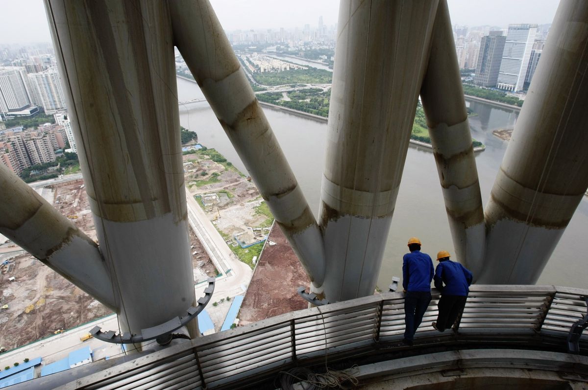 Guangzhou TV & Sightseeing Tower Nears Completion GUANGDONG, CHINA - JULY 3:  (CHINA OUT)  Workers look over a balcony of the Canton Tower, the world's tallest TV Sightseeing Tower, on July 3, 2009 in GuangZhou, Guangdong Province of China. The tower will stand at 610 m tall and is due for completion by the end of 2009. (Photo by Huang Hao/Visual China Group via Getty Images)