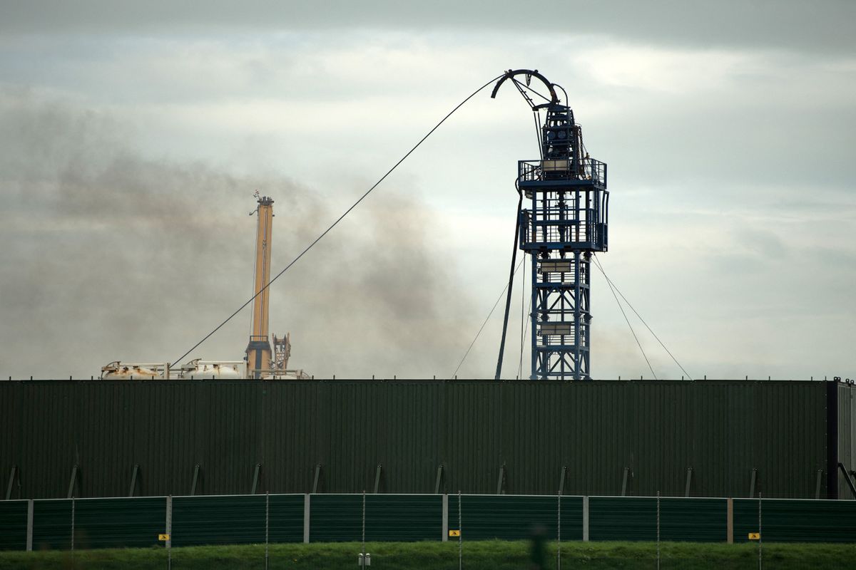 Smoke rises from the Preston New Road drill site where energy firm Cuadrilla Resources have commenced fracking (hydraulic fracturing) operations to extract shale gas, near the village of Little Plumpton, near Blackpool, north west England on October 16, 2018. - Anti-fracking protesters took to the streets again on Tuesday as work continued on Britain's first horizontal shale-gas well after the High Court in London dismissed a last-minute request for an injunction.