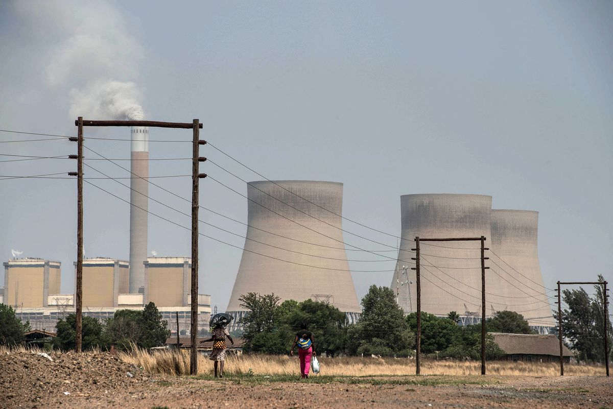 A woman walks past the Kendal power station on September 28, 2016 on the outskirts of Witbank. - The much-anticipated South African request for a proposal for a nuclear plan will not be issued on September 30, as mooted by Energy Minister Tina Joemat-Pettersson earlier this month. (Photo by MUJAHID SAFODIEN / AFP)