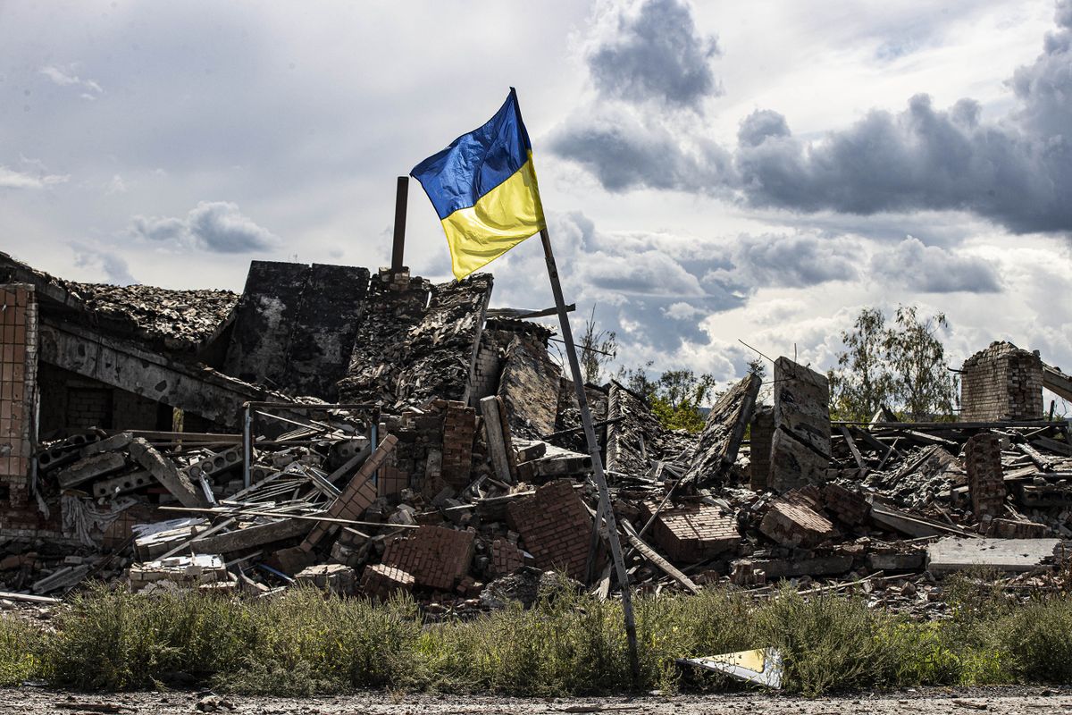 DOLINA, DONETSK, UKRAINE - SEPTEMBER 24: Ukrainian flag waves in a residential area heavily damaged in the village of Dolyna in Donetsk Oblast, Ukraine after the withdrawal of Russian troops on September 24, 2022. Many houses and St. George's Monastery were destroyed in the Russian attacks. Ukraine said on Saturday that its soldiers were entering the city of Lyman in the eastern region of Donetsk, which Russia had annexed a day earlier. Metin Aktas / Anadolu Agency (Photo by Metin Aktas / ANADOLU AGENCY / Anadolu Agency via AFP)