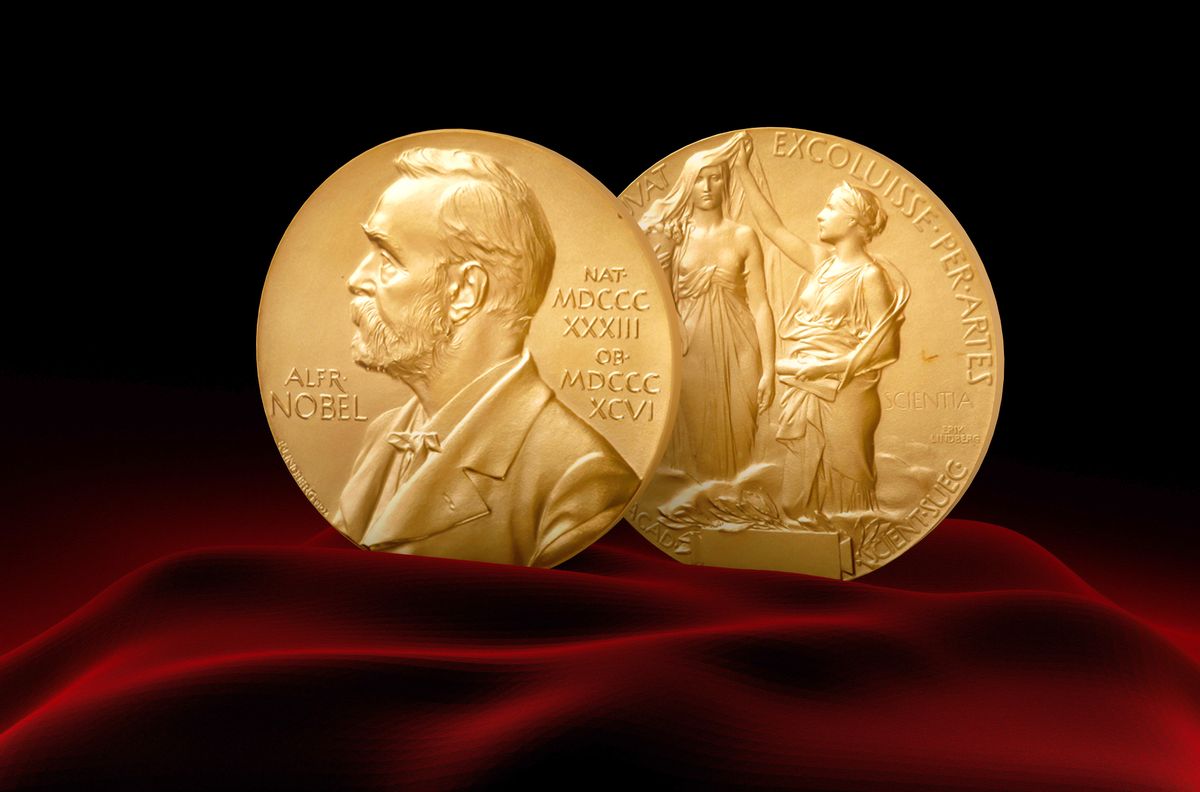 Nobel,Prize,Medal,Standing,On,A,Platform.,Red,And,Black Nobel Prize Medal standing on a platform. Red and black background.