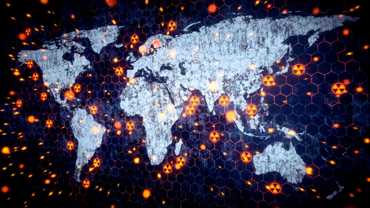Worldwide Nuclear Conflict Concept, A world map outline with glowing nuclear warning symbol scattered around. The world map is very dirty and scratched with glowing particles of dust exploding outward.